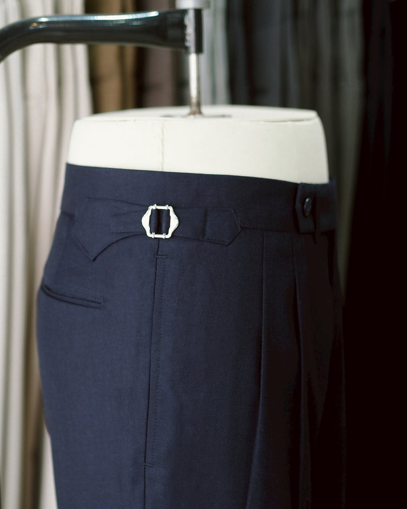 Navy Edge pleated belt trousers