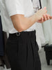 Black tapered pleated trouers